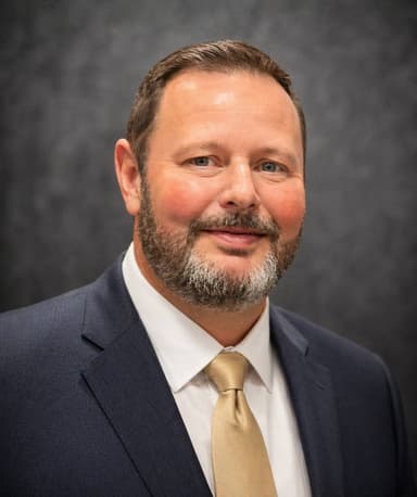 Professional headshot of Derek Mitchell